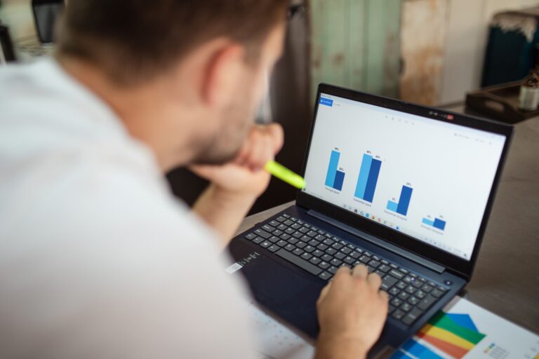 A real laptop screen showing business performance charts during a campaign review