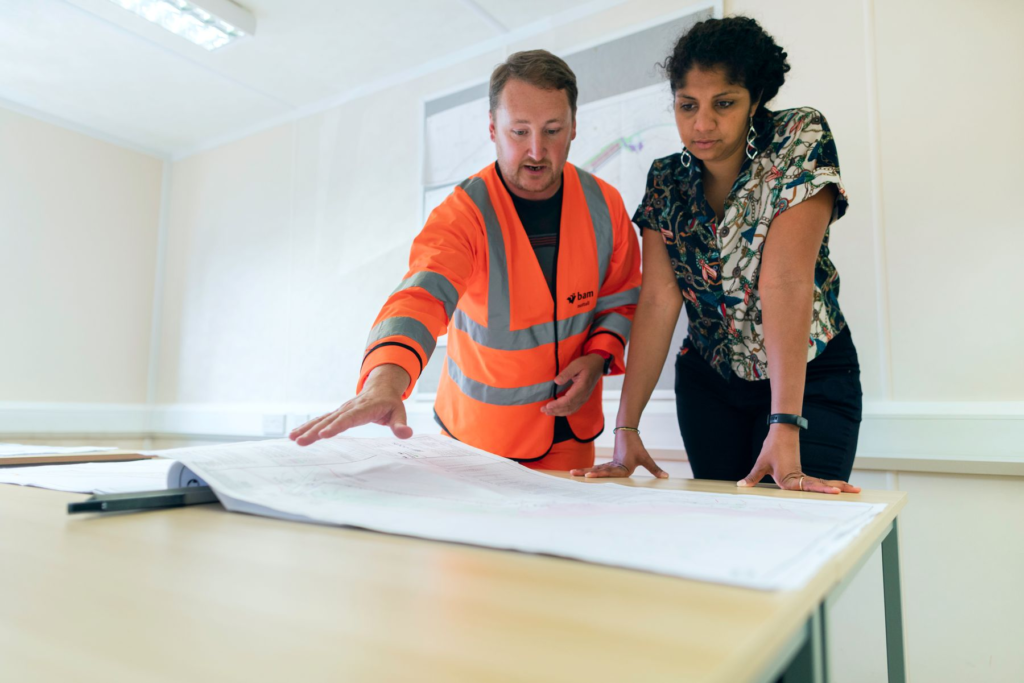 Engineers reviewing a project blueprint together
