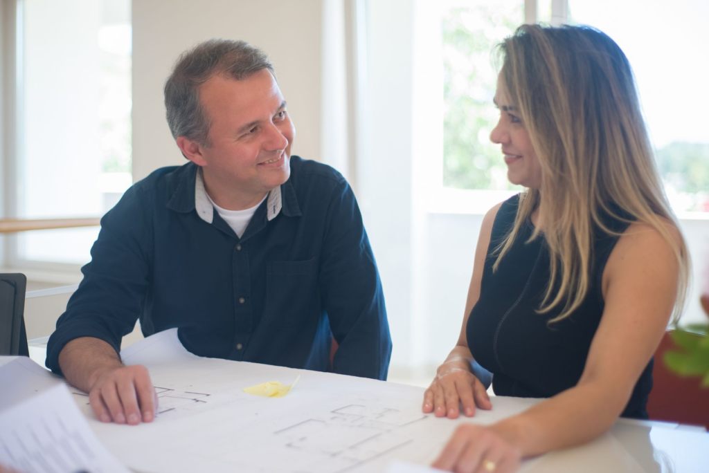 A team discussing plans and project details around a table