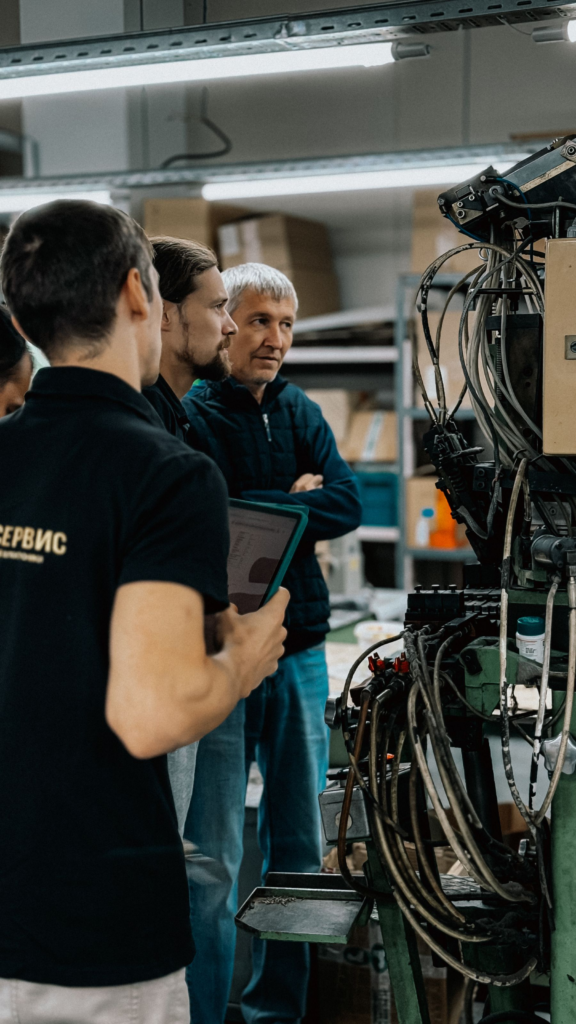 Engineers discussing work on a factory floor